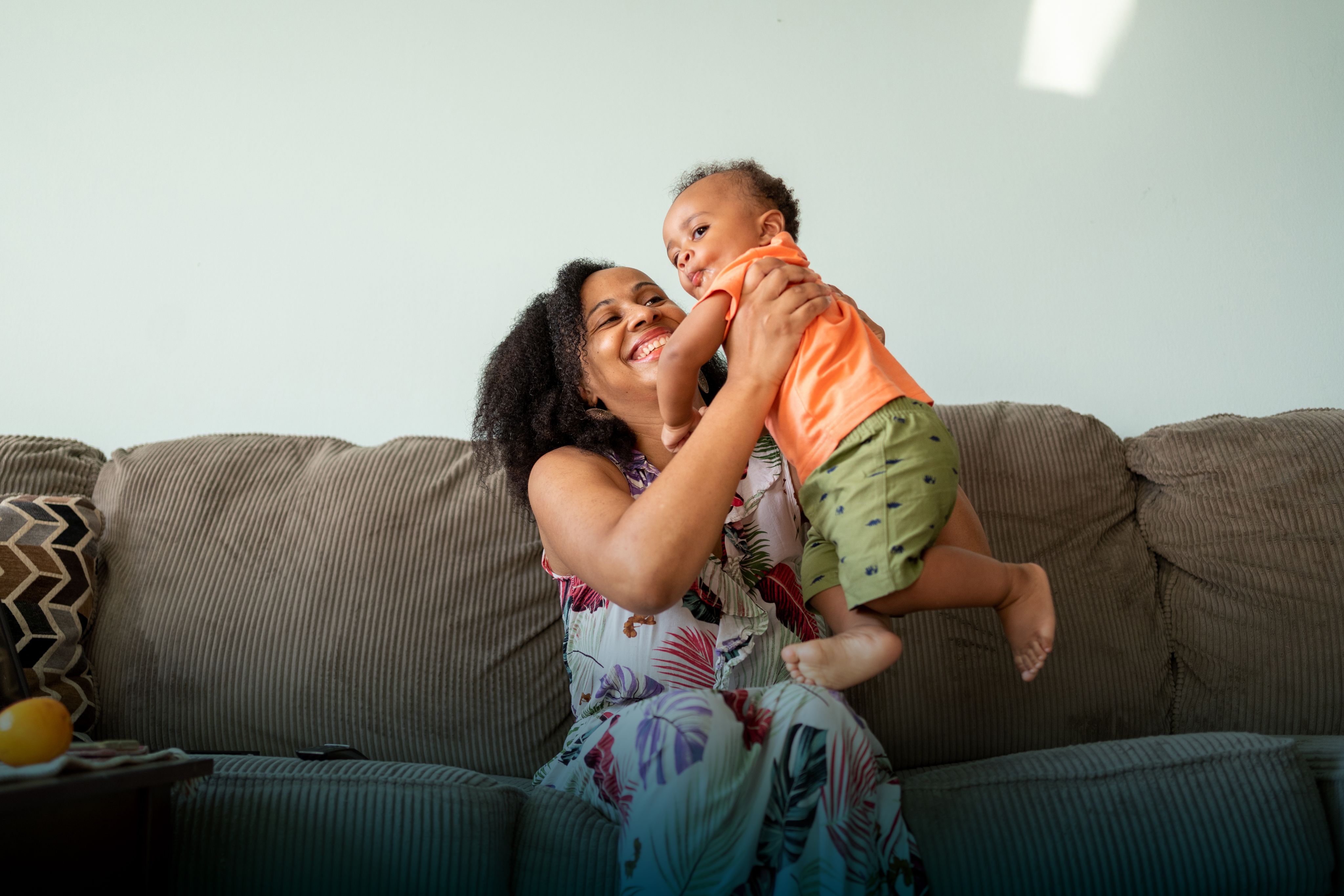 Our Commitment 3, mother and child at home on sofa